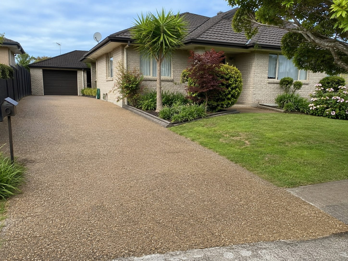 Sandy brown exposed aggregate driveway Auckland